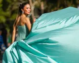Elegante Frau in einem mintgrünen, bestickten Kleid mit weitem Rock, bereit für einen Anlass, bei dem "black tie optional" gilt.