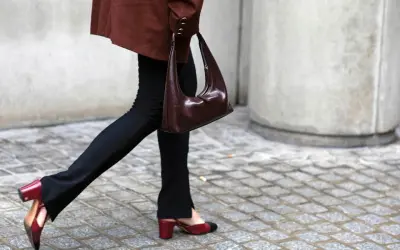 Schwarze Stoffhose kombinieren: Ein schicker Look mit brauner Tasche und zweifarbigen Slingback-Schuhen.
