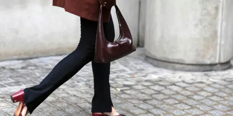 Schwarze Stoffhose kombinieren: Ein schicker Look mit brauner Tasche und zweifarbigen Slingback-Schuhen.