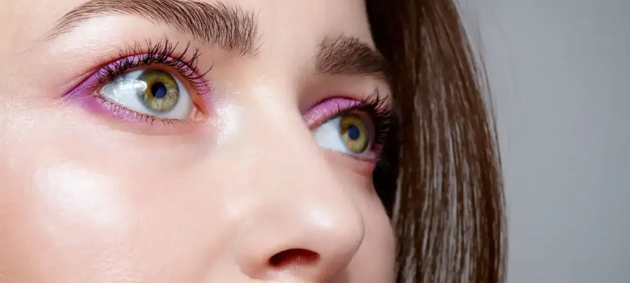 Augen schminken ab 50: Ein zartes Lila-Lid und Mascara betonen die grünen Augen.