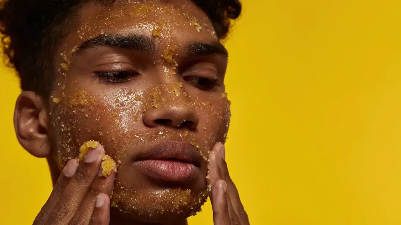 Mann mit Honig-Peeling im Gesicht, das die positive Wirkung auf die Haut zeigt.